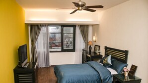 A hotel room with a bed, a TV, a desk, and a window with curtains. - ZO Star Tam Dao (Tam Dao)