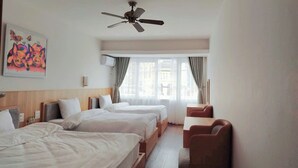 A hotel room with two beds, a ceiling fan, a window with curtains, and a desk with a chair. - ZO Star Tam Dao (Tam Dao)