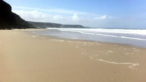 A beach with a clear sky and calm sea. - Spectacular one bedroom apartment , incredible coastal views, walk to the  beach (Porthtowan)
