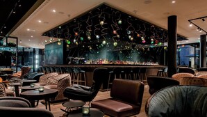 A modern bar area with seating and a bar counter.