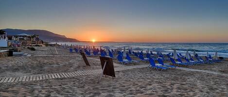 On the beach, sun-loungers, beach umbrellas