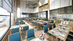 Un restaurante moderno con techos altos, iluminación colgante y una combinación de asientos tipo cabina y mesas.