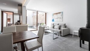 A modern living room with a dining area, a sofa set, and a fireplace. - Casa Bugera, Beautiful restored house in Pollensa (Pollença)