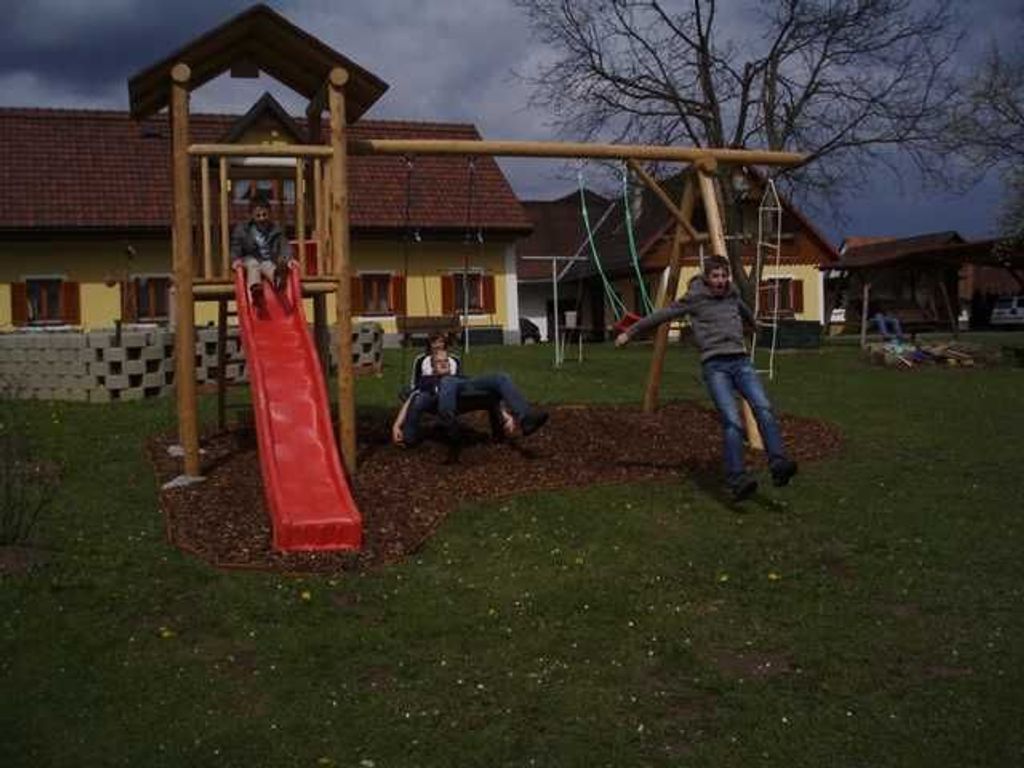 A playground with a slide and swings.