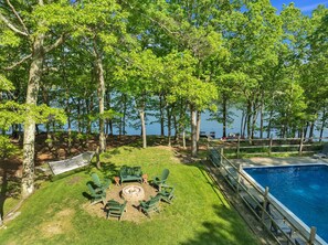 A poolside area with a fire pit and outdoor seating. - Lakefront Retreat, Private Pool, Hot Tub, Game Rm, Ping Pong, Foosball (Bushkill)