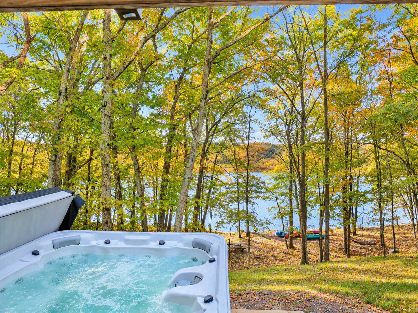 A hot tub with a view of a lake and trees.