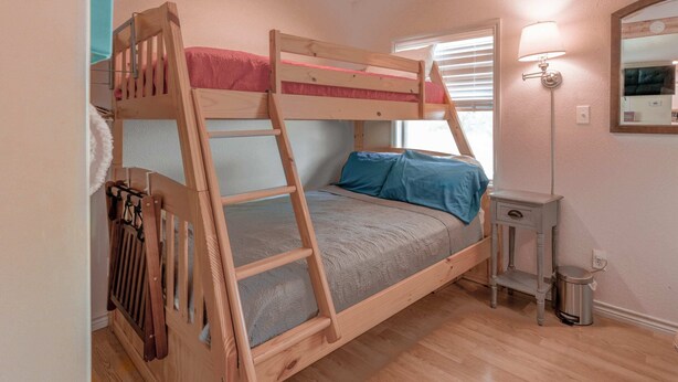 A bunk bed with a ladder, a bedside table, and a lamp. - Hidden Harbor-Lakefront on Secluded Cove w/Dog Run (Kingsland)