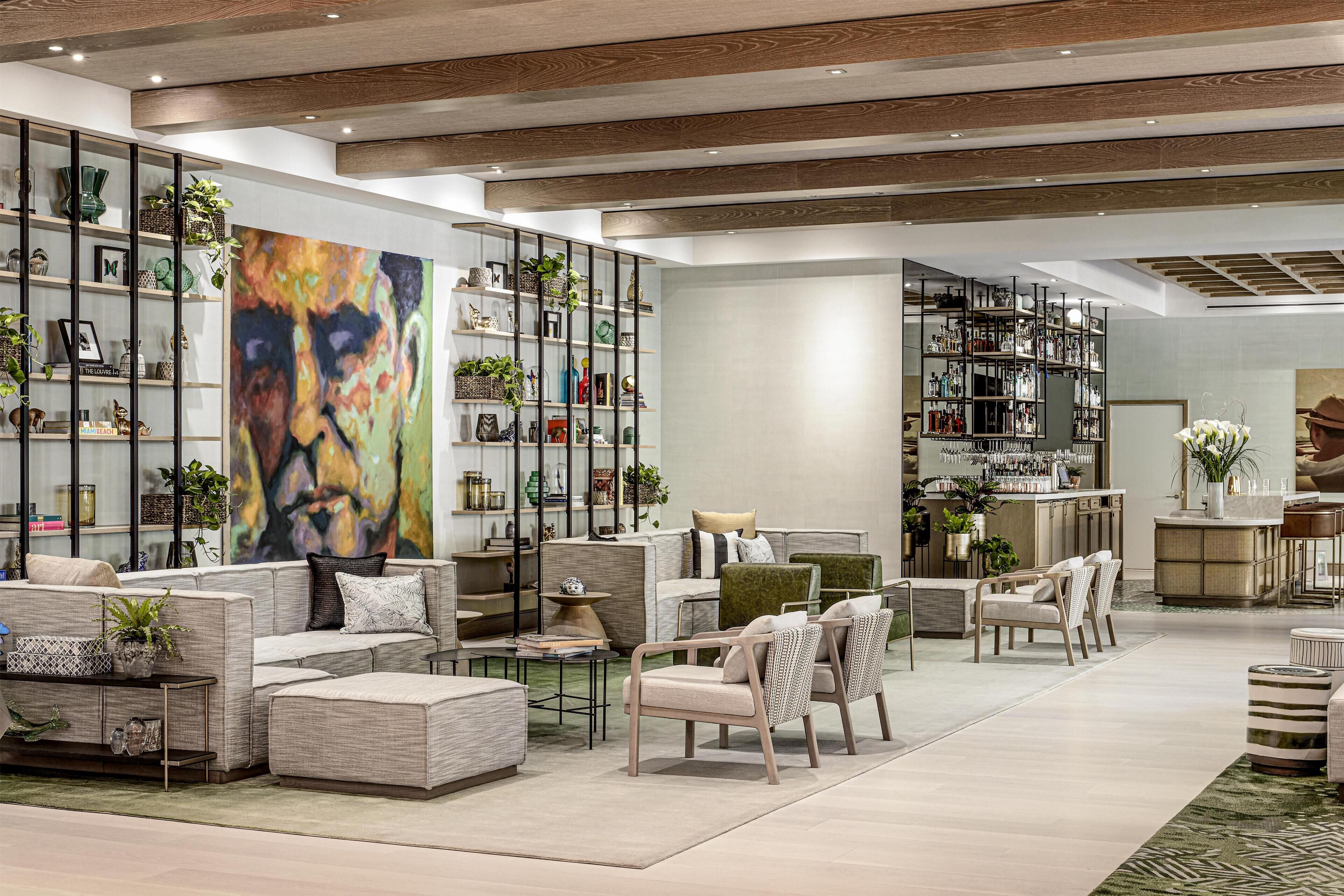 A spacious, modern lounge area with a variety of seating options, including sofas, chairs, and a bar area.
