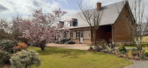 Traditional house with a charming garden and porch area.
