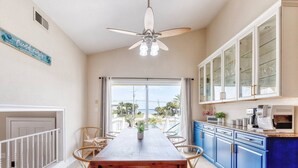 A kitchen with a dining area, a ceiling fan, and a view of the outdoors. - Summer SPECIAL! Steps 2 Beach! Waterview! Pets Welcome! (Pensacola)