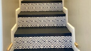 A staircase with black steps and white geometric patterns. - False River Waterfront property (Jarreau)