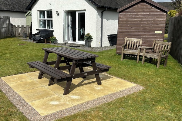 The back of the cottage with the new picnic patio and new composite decking.