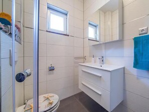 Shower, hair dryer, towels, toilet paper