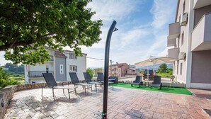 A patio area with outdoor seating and a water feature. - Holiday Home J&D No.3-Six Bedroom House  with Pool (Podstrana)