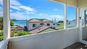 A balcony with a view of a house and the ocean. - Bermagui Bay Beach House 2.     
Historic charm.  Heart of Bermagui. (Bermagui)