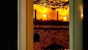 A room with a fireplace, a stone wall, and a door. - Woodstock Farmhouse /Hot tub, Gardens,EV charger, Firepit, Pet/Family Friendly (Saugerties)