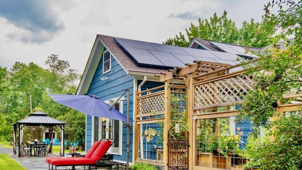 A blue house with a covered patio, a gazebo, and a garden. - Woodstock Farmhouse /Hot tub, Gardens,EV charger, Firepit, Pet/Family Friendly (Saugerties)