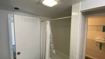 A bathroom with a shower, a toilet, and a sink.