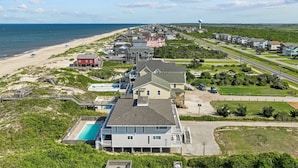 A coastal residential area with houses, a beach, and a water tower.