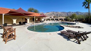 A pool area with lounge chairs, a covered seating area, and mountains in the background. - Tucson Townhome w/ Private Patio & Mtn Views! (Tucson)