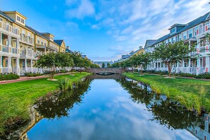 Stroll along the serene waterfront promenade, lined with traditional buildings and lush greenery.