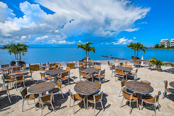 Relax in a secluded outdoor space overlooking a serene body of water.