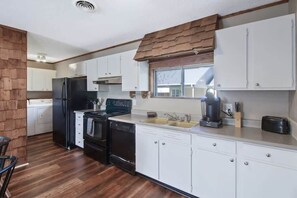 Enjoy cooking in this well-equipped kitchen with a refrigerator, stove, dishwasher, and coffee maker.
