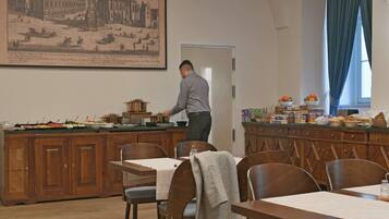 Un'area pranzo con un buffet, mobili in legno e un grande quadro appeso al muro.