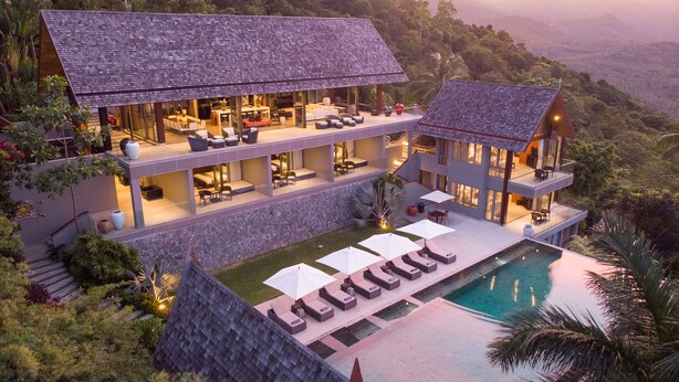 A modern villa with a large swimming pool, multiple balconies, and lush surrounding vegetation. - Suralai by Elite Havens (Koh Samui)