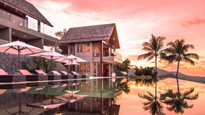 A resort with a pool, lounge chairs, and umbrellas. - Suralai by Elite Havens (Koh Samui)
