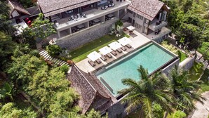A large, multi-story house with a swimming pool, surrounded by lush greenery. - Suralai by Elite Havens (Koh Samui)