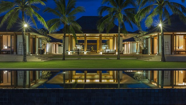 A modern resort with a pool, palm trees, and a well-lit outdoor area. - Jivana Beach Villas (Takua Thung)