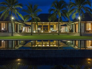 A modern resort with a pool, palm trees, and a well-lit outdoor area. - Jivana Beach Villas (Takua Thung)