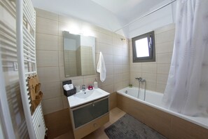 Combined shower/tub, hair dryer, towels, toilet paper