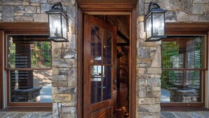 A stone-clad entrance with a wooden door, flanked by two windows with wooden shutters. - Breakaway Ridge - Mountain Tops (Blue Ridge)