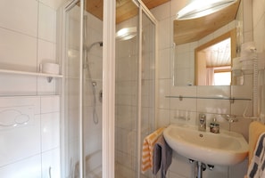 Shower, hair dryer, towels, toilet paper