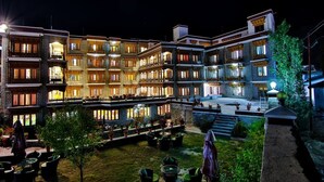 A multi-story hotel with outdoor seating areas and a courtyard. - TIH Hotel Shangrila-Ladakh (Leh)