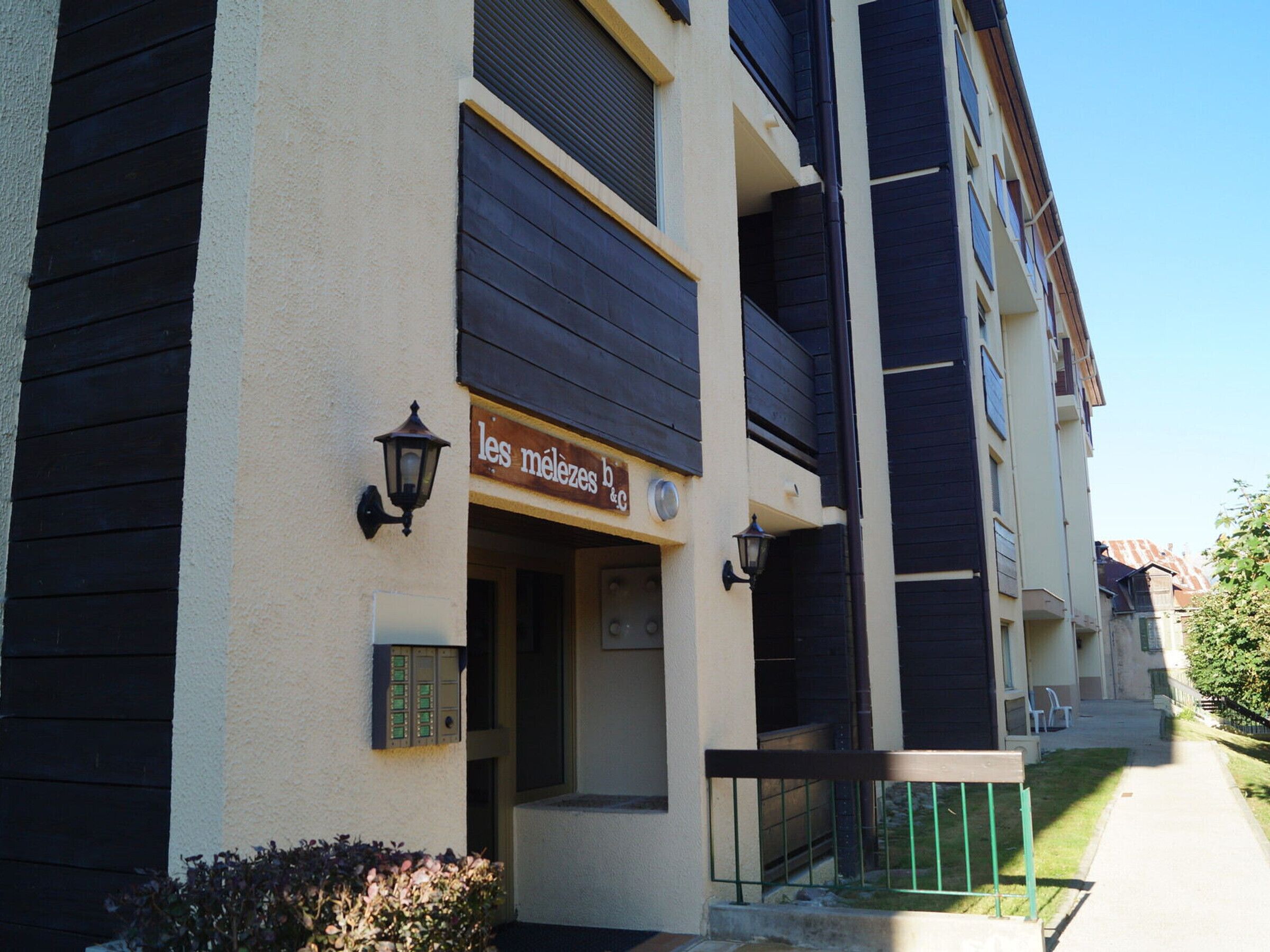 A building with a sign reading "les melezes b & c" indicating a business establishment.