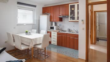 Family Apartment, 2 Bedrooms, Balcony | Private kitchen | Fridge, stovetop, coffee/tea maker, electric kettle