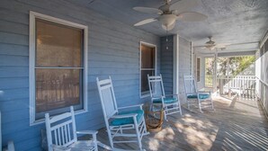 A porch with white rocking chairs and a ceiling fan. - A Some Place Special Minutes to Beach Sleeps 10 (Pawleys Island)