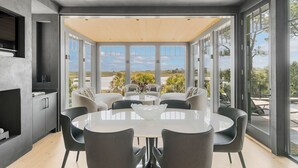 A modern kitchen with a large island, built-in appliances, and a view of the outdoors. - Ocean, golf and lagoon views, complete renovation luxury home (Kiawah Island)