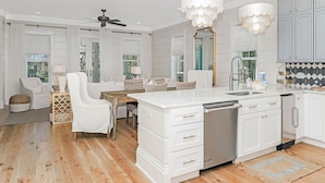 A modern kitchen with white cabinetry, a central island, and pendant lighting. - Private Pool And Gulf Views- Sugar Magnolia By Royal Destinations (Santa Rosa Beach)