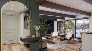 A modern living room with a large mirror, a fireplace, and a view of the outdoors. - Fully Renovated Aspen Core 2/2 w A/C on River! (Aspen)