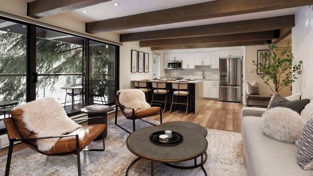 A modern kitchen with stainless steel appliances, a dining area with leather chairs, and a large window offering a view of trees. - Fully Renovated Aspen Core 2/2 w A/C on River! (Aspen)