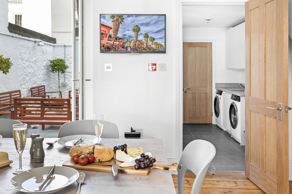 The utility room with washer dryer and a handy cloakroom.