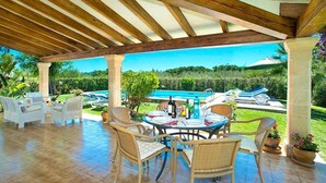 A covered patio with wicker furniture, a pool, and a view of the landscape. - Villa Geranios, country house a few minutes driving from Pollensa (Pollença)