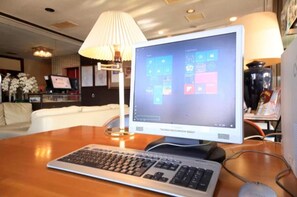 Work and unwind in style with a comfortable sofa and modern workspace.