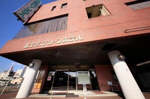 Stunning building with a prominent entrance, marked by a glass door and Japanese sign.