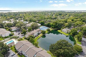 A residential area with houses, a swimming pool, and a lake. - Water View - optional BIKES - Walk 2 Pier Village (St. Simons Island)