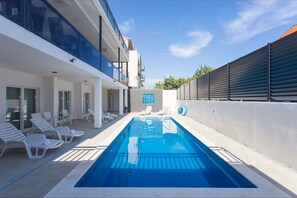 Relax by the rectangular pool surrounded by lounge chairs and take in the views from the building's large windows.